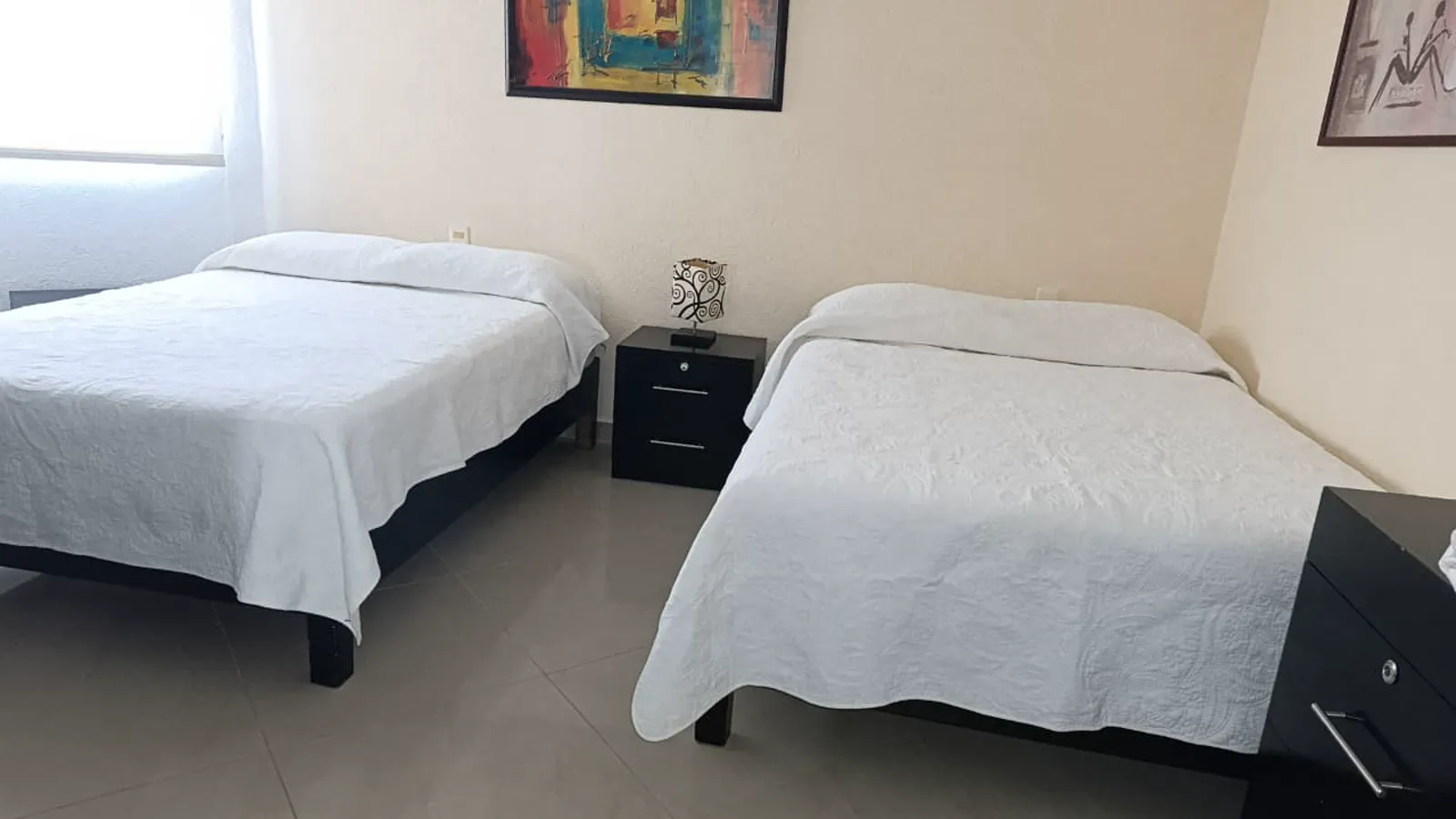 Recámara principal con dos camas matrimoniales