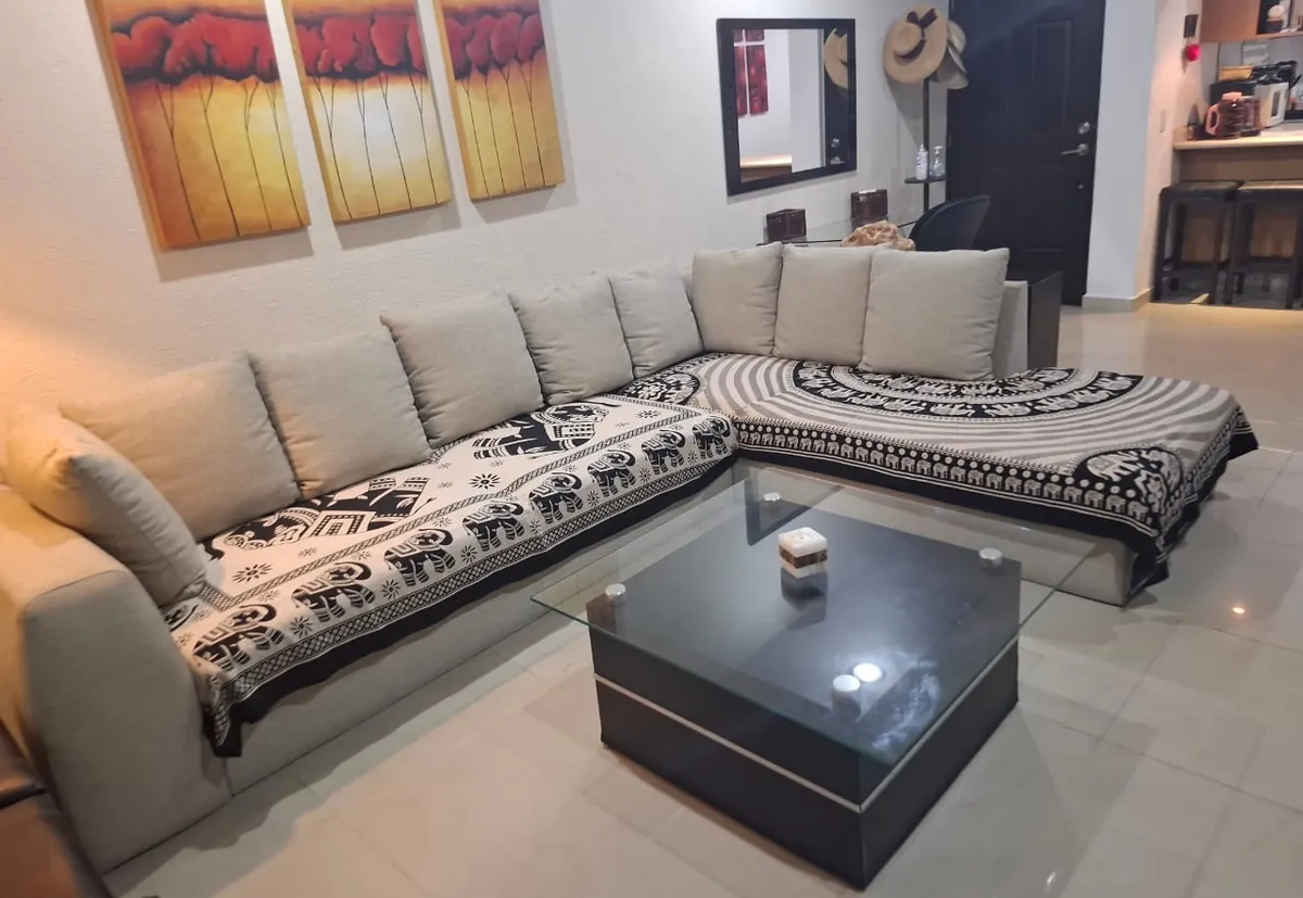 Sala con sillón seccional en L y mesa de centro de vidrio